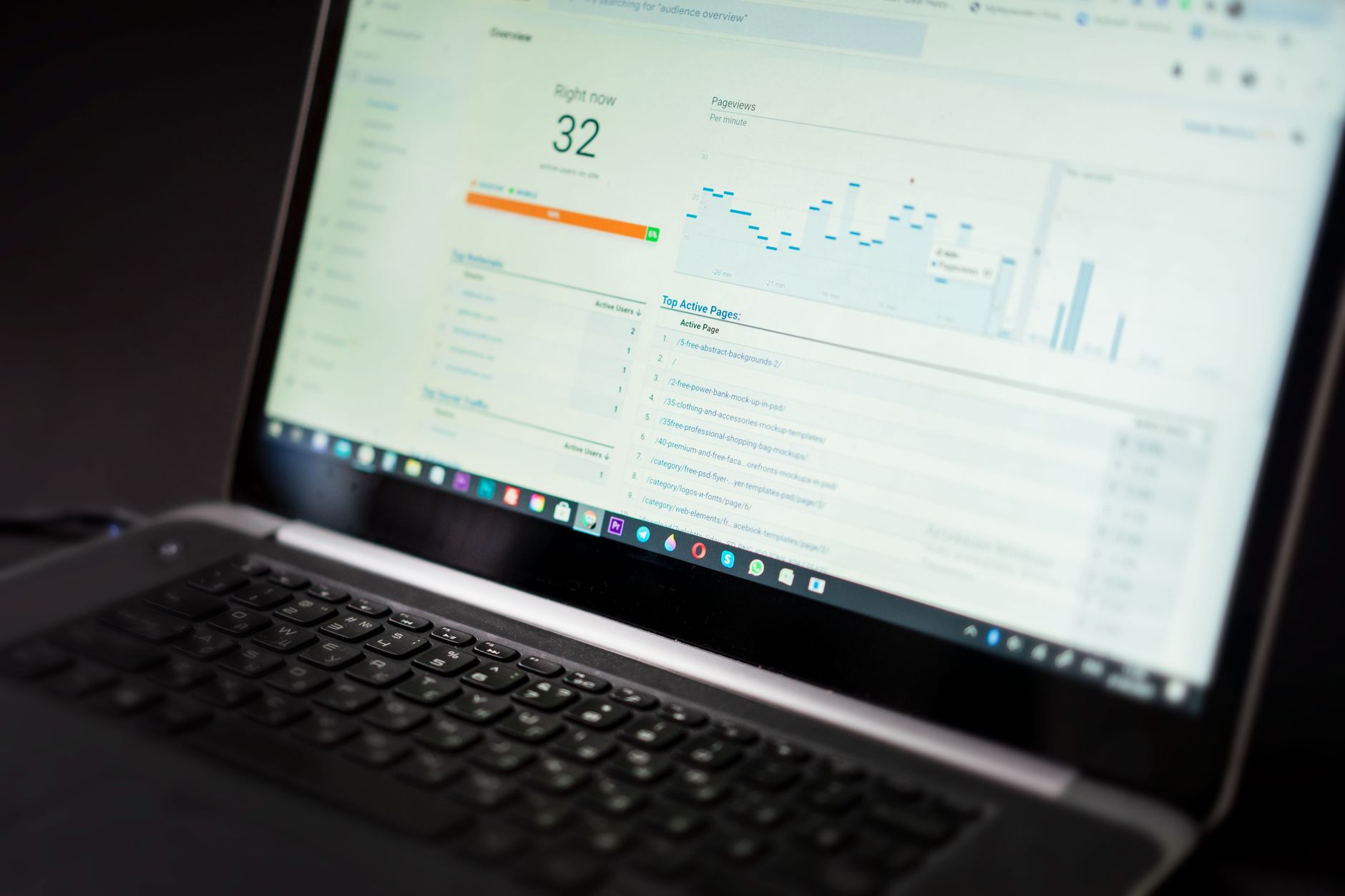 A person types on a laptop while an SEO content score dashboard is visible on screen.
