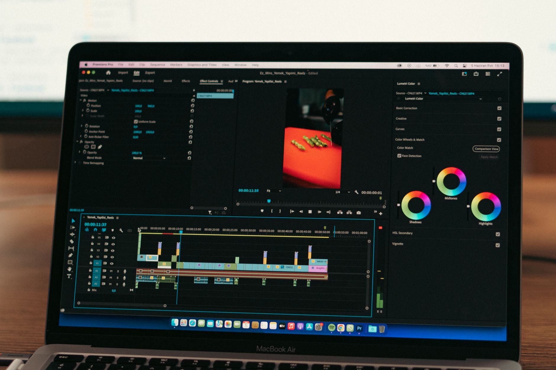 Video editor timeline open on a desktop monitor showing clips and color controls